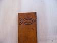 This is a leather Book Mark with a fish symbol on top.